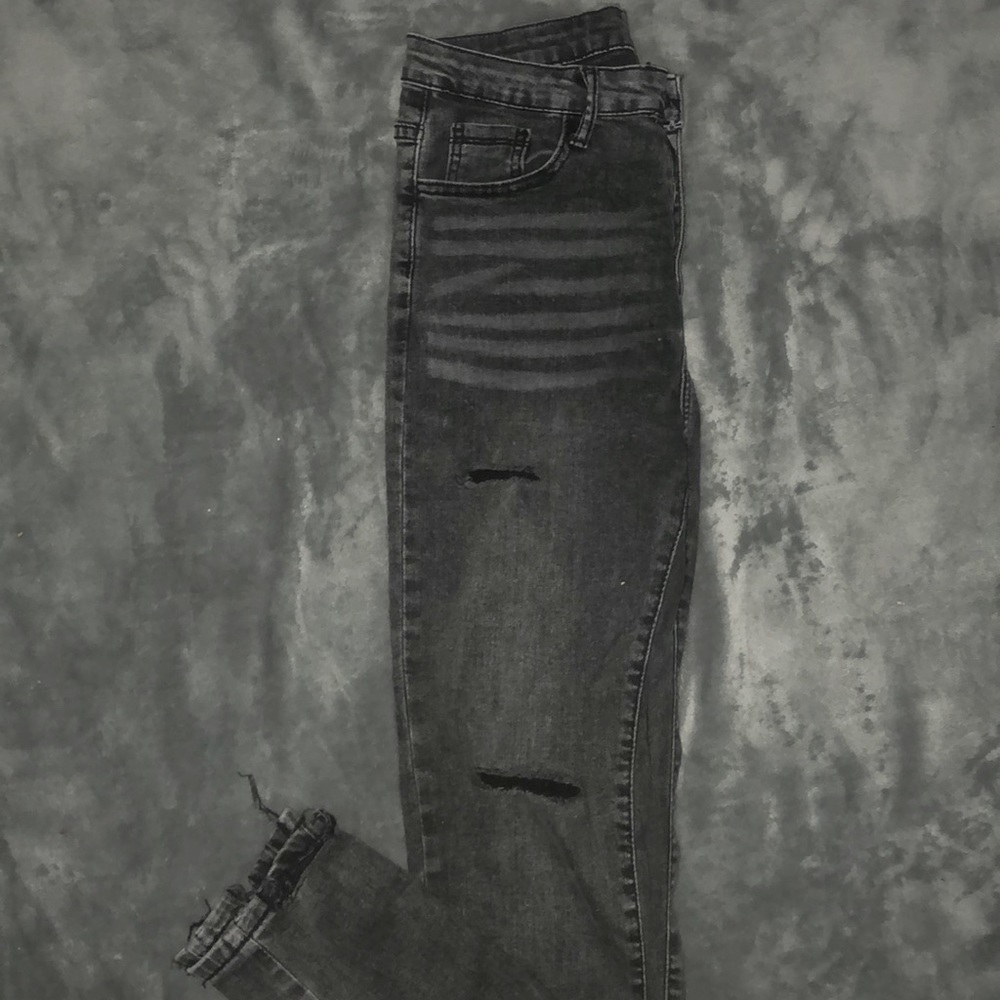 slightly black ripped jeans